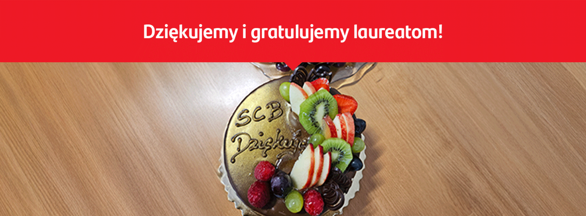 na zdjęciu jest tort z napisem SCB Dziękuję, a na górze hasło Dziękujemy i gratulujemy laureatom!