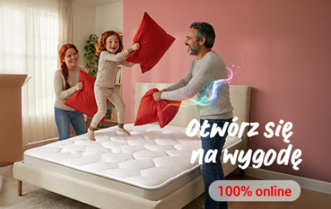 Baner promujący kredyt online.  Rodzina (mama, tata i córka) bawiąca się czerwonymi poduszkami na łóżku